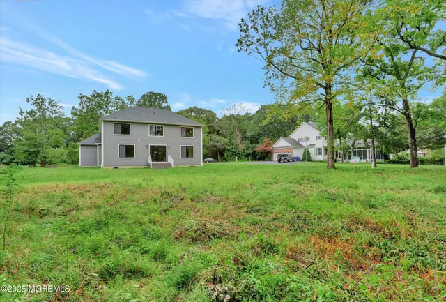 a view of staircase with lots of frames on wall and wooden floor