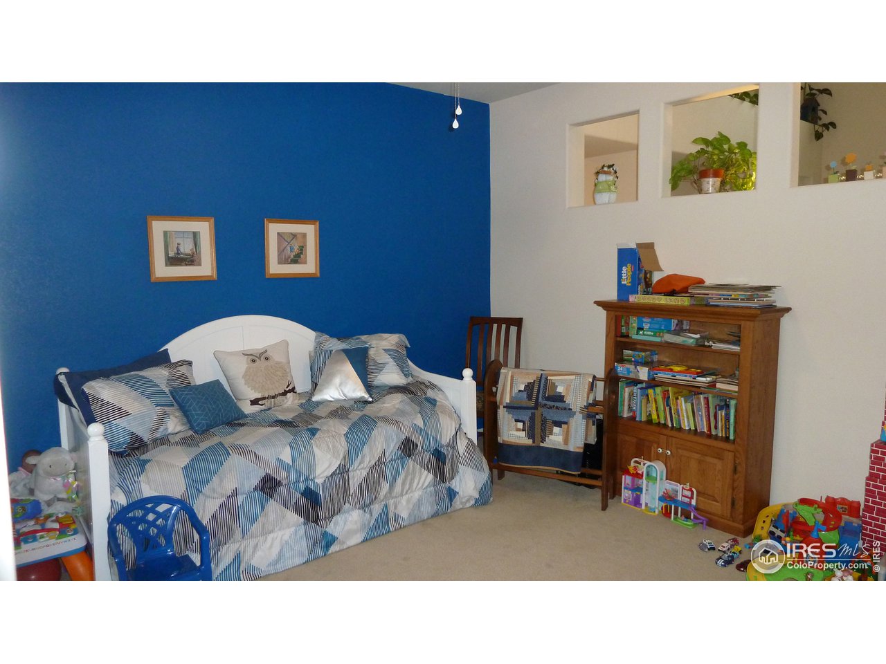 8121 Raspberry Drive Frederick, CO 80504 - Photo 12 of 38 a living room with furniture and a shelf