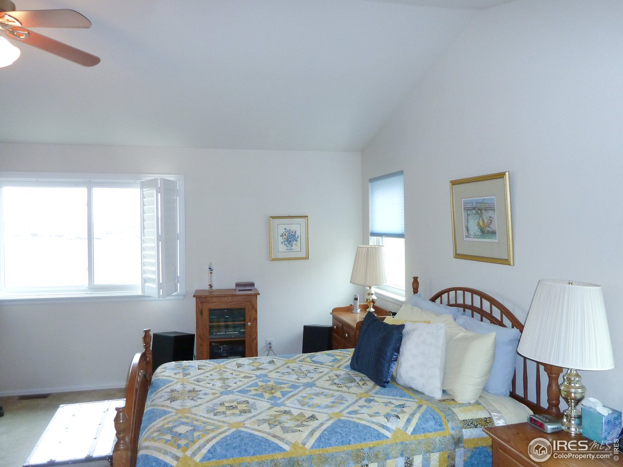 8121 Raspberry Drive Frederick, CO 80504 - Photo 24 of 38 a bedroom with a bed and a lamp on dresser