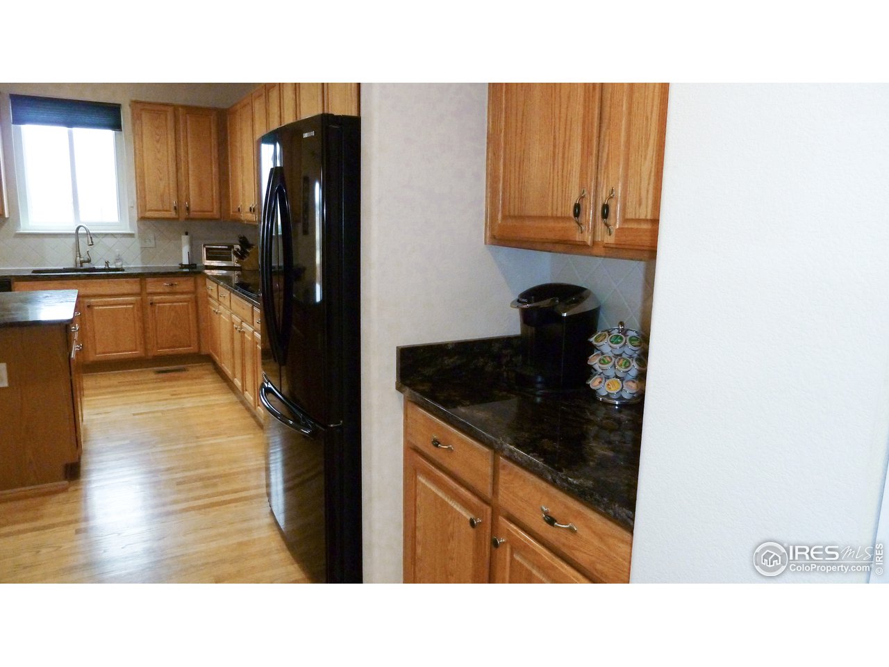 8121 Raspberry Drive Frederick, CO 80504 - Photo 7 of 38 a kitchen with a refrigerator stove and wooden cabinets