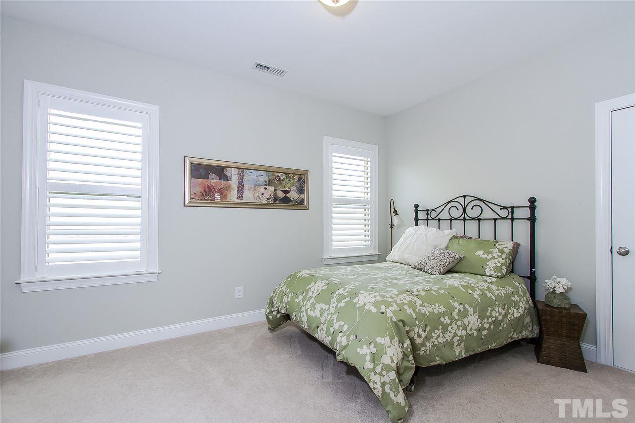 2804 Romealia Lane Raleigh, NC 27613 - Photo 17 of 25 a bedroom with a bed next to a window