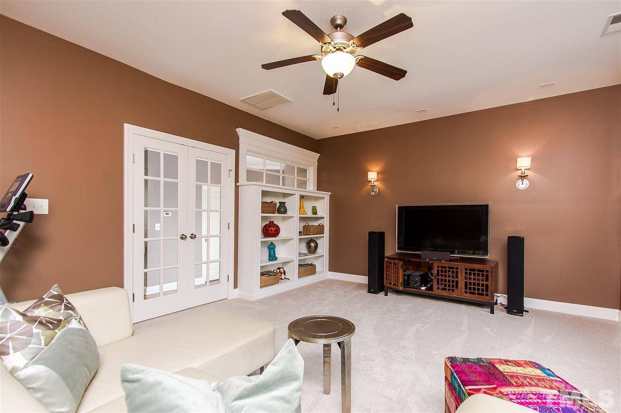 2804 Romealia Lane Raleigh, NC 27613 - Photo 19 of 25 a living room with furniture and a flat screen tv