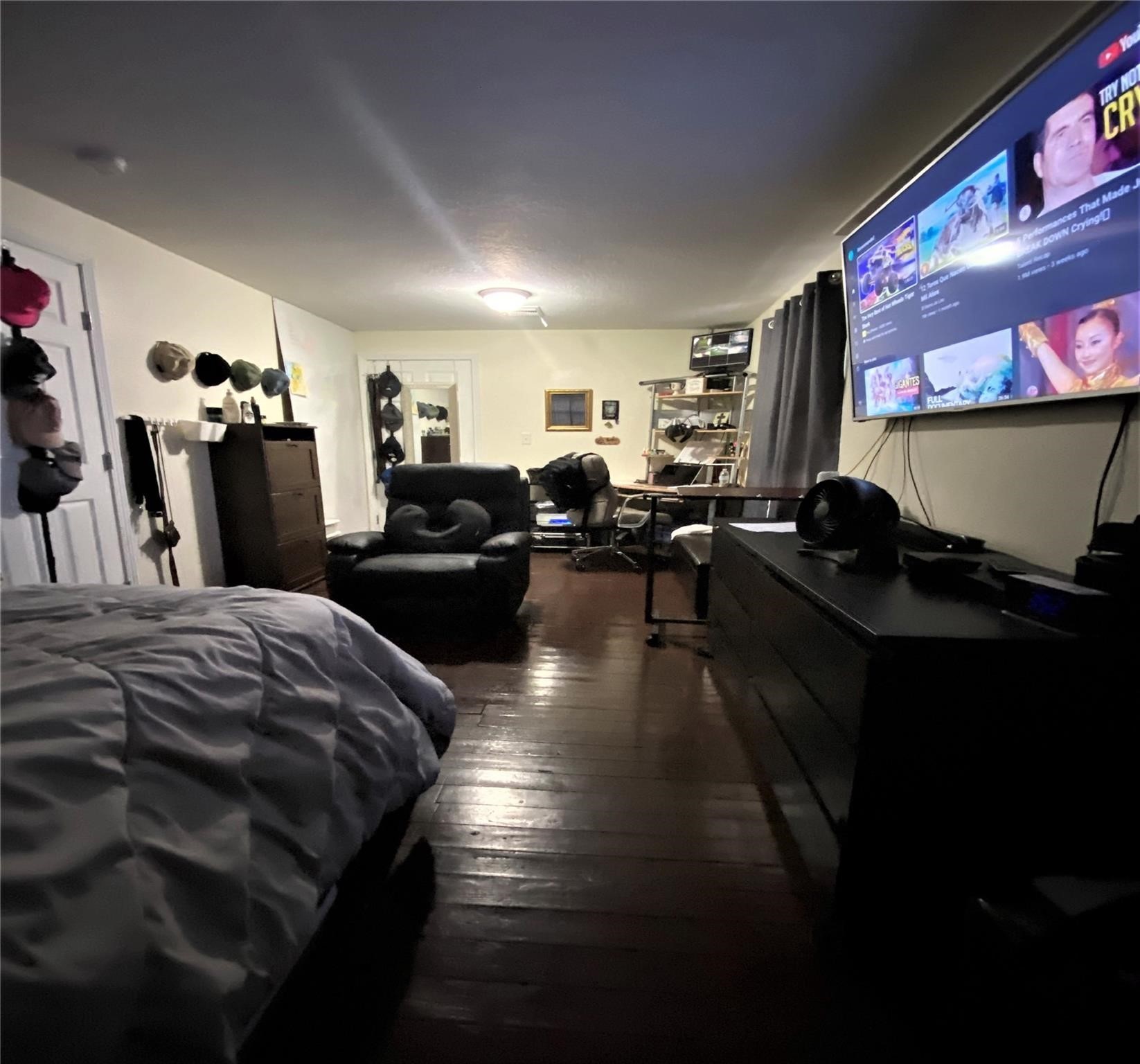 4802 Ward Street Houston, TX 77021 - Photo 3 of 16 a bed room with a bed and a television