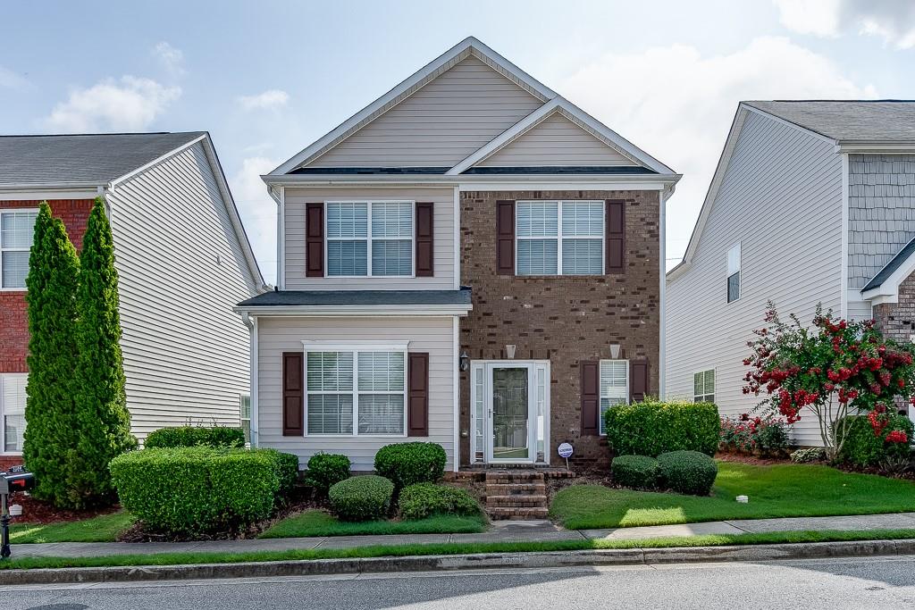 3166 Imperial Circle Southwest Atlanta, GA 30311 - Photo 1 of 1 a front view of a house with a garden and plants