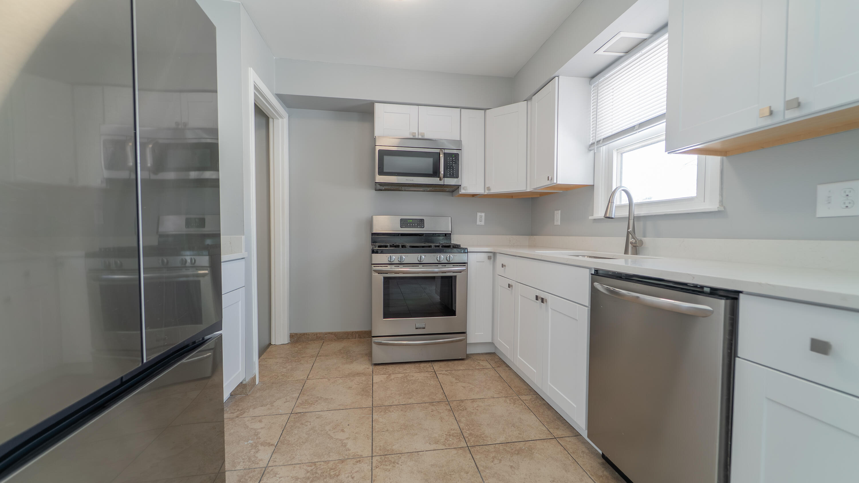 9380 Mckinley Street Crown Point, IN 46307 - Photo 11 of 41 a kitchen with a sink stove and microwave