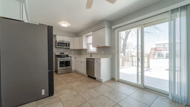 a kitchen with a refrigerator a sink and a stove top oven