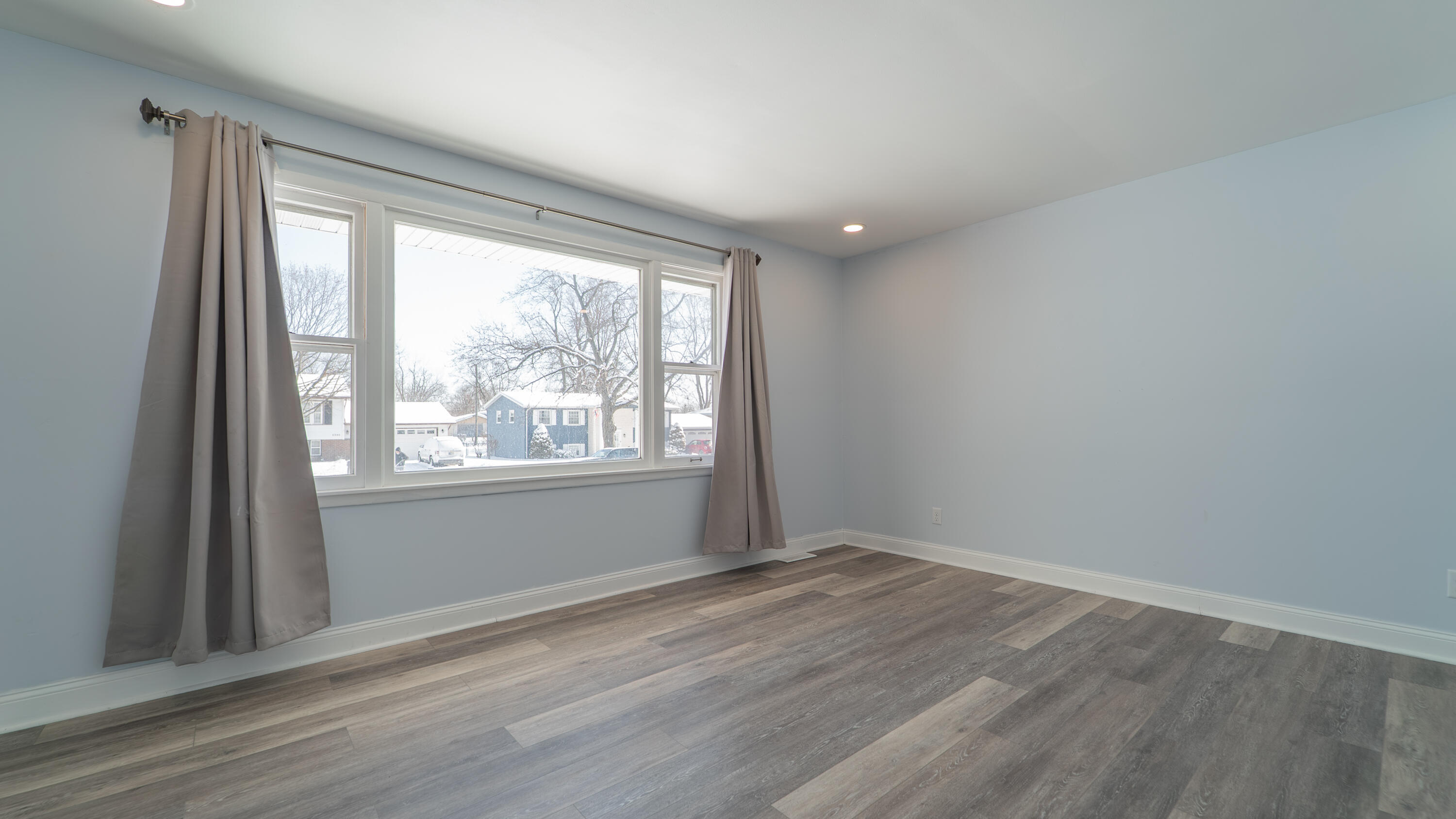 9380 Mckinley Street Crown Point, IN 46307 - Photo 18 of 41 a view of an empty room with wooden floor and a window