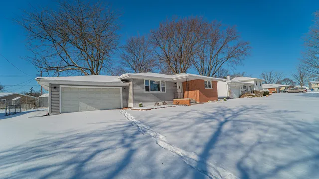 a view of house with outdoor space and parking