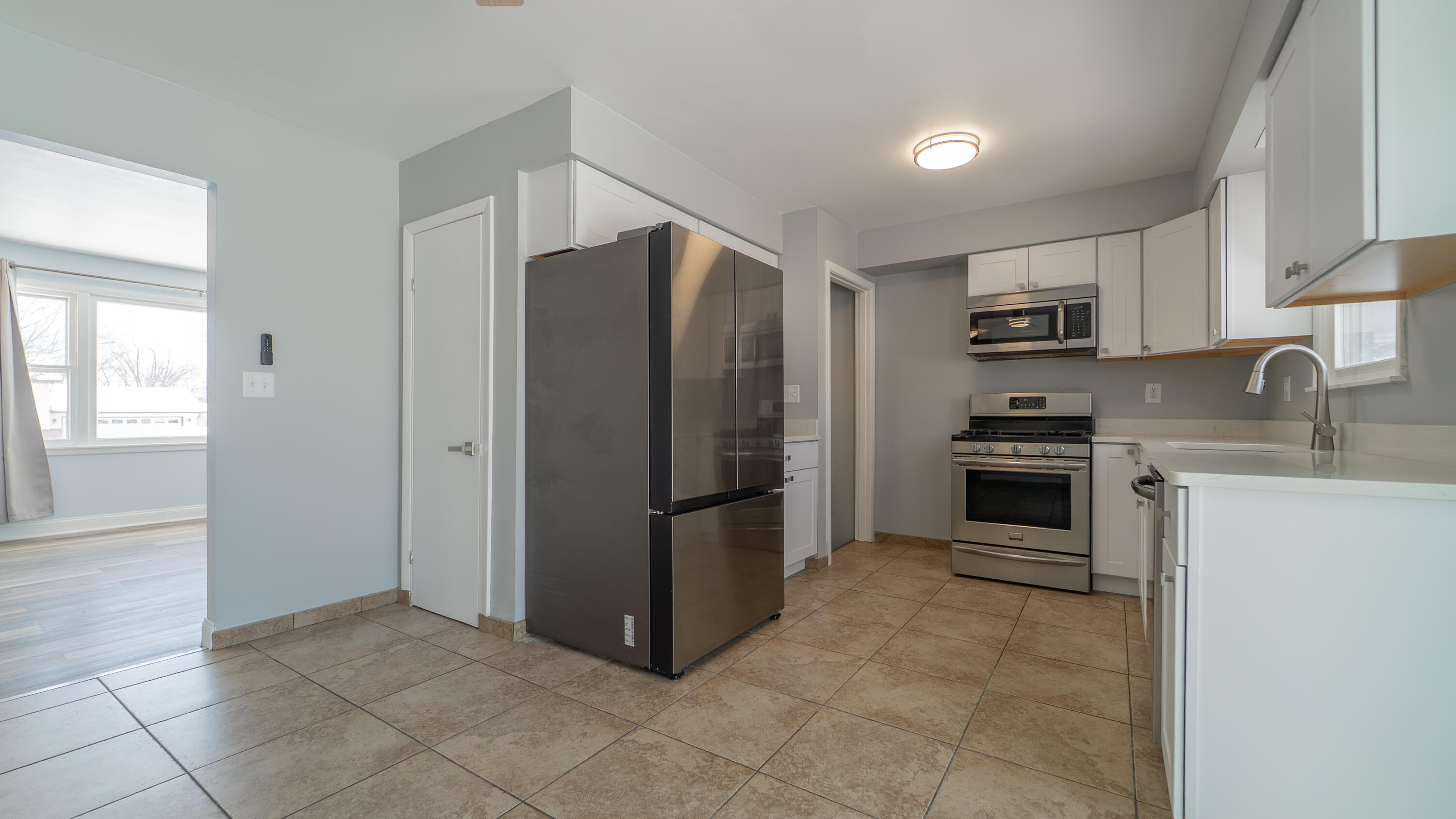 9380 Mckinley Street Crown Point, IN 46307 - Photo 10 of 41 a kitchen with granite countertop a refrigerator and a stove top oven
