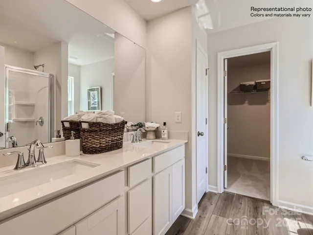 a bathroom with a sink a mirror and a shower