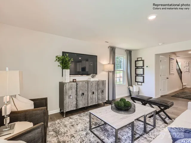 a living room with furniture kitchen view and a table