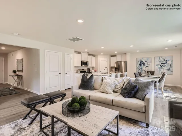 a living room with furniture wooden floor and a rug