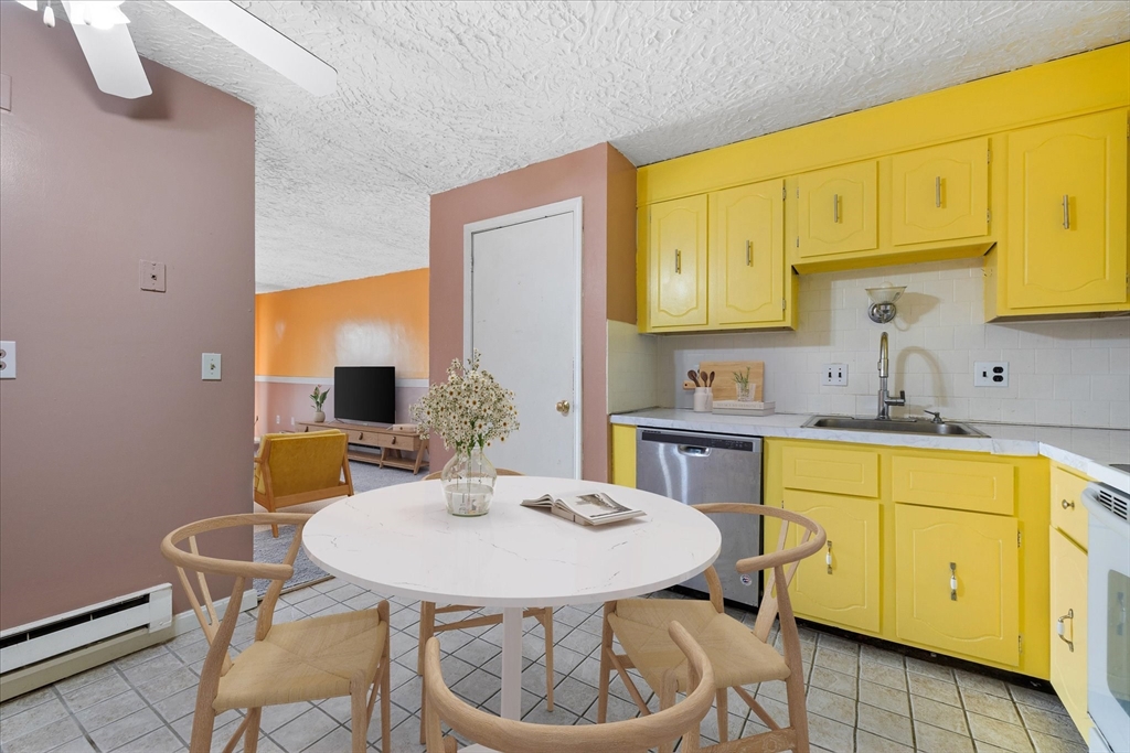 310 Codman Hill Road, Unit 35D Boxborough, MA 01719 - Photo 2 of 9 a kitchen with a sink cabinets and chair