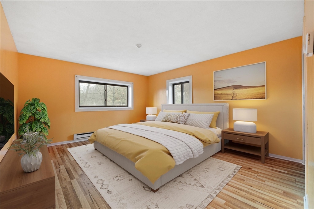 310 Codman Hill Road, Unit 35D Boxborough, MA 01719 - Photo 3 of 9 a bedroom with a bed and a night stand