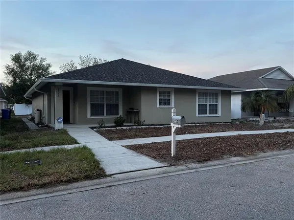 a front view of a house with garage and yard