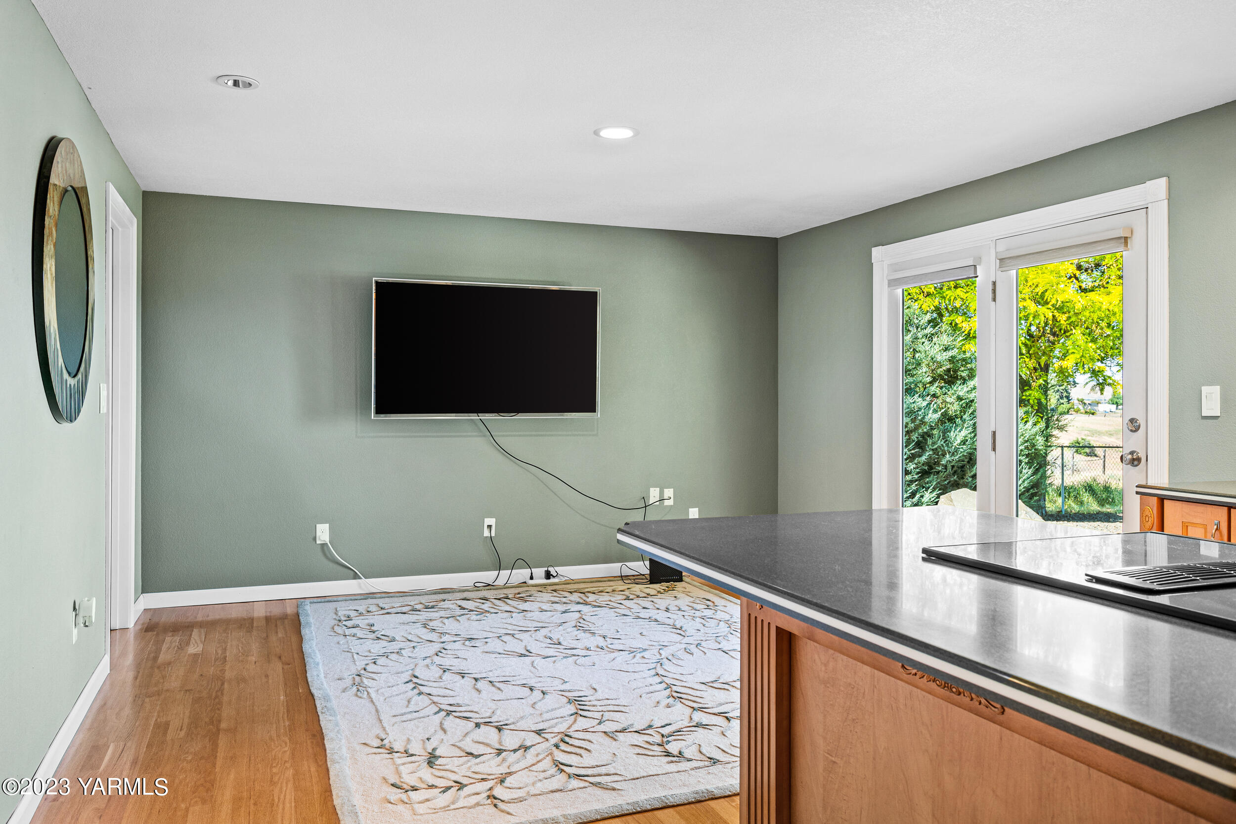 13518 Fisk Road Yakima, WA 98908 - Photo 14 of 58 a view of a livingroom with wooden floor and a flat screen tv