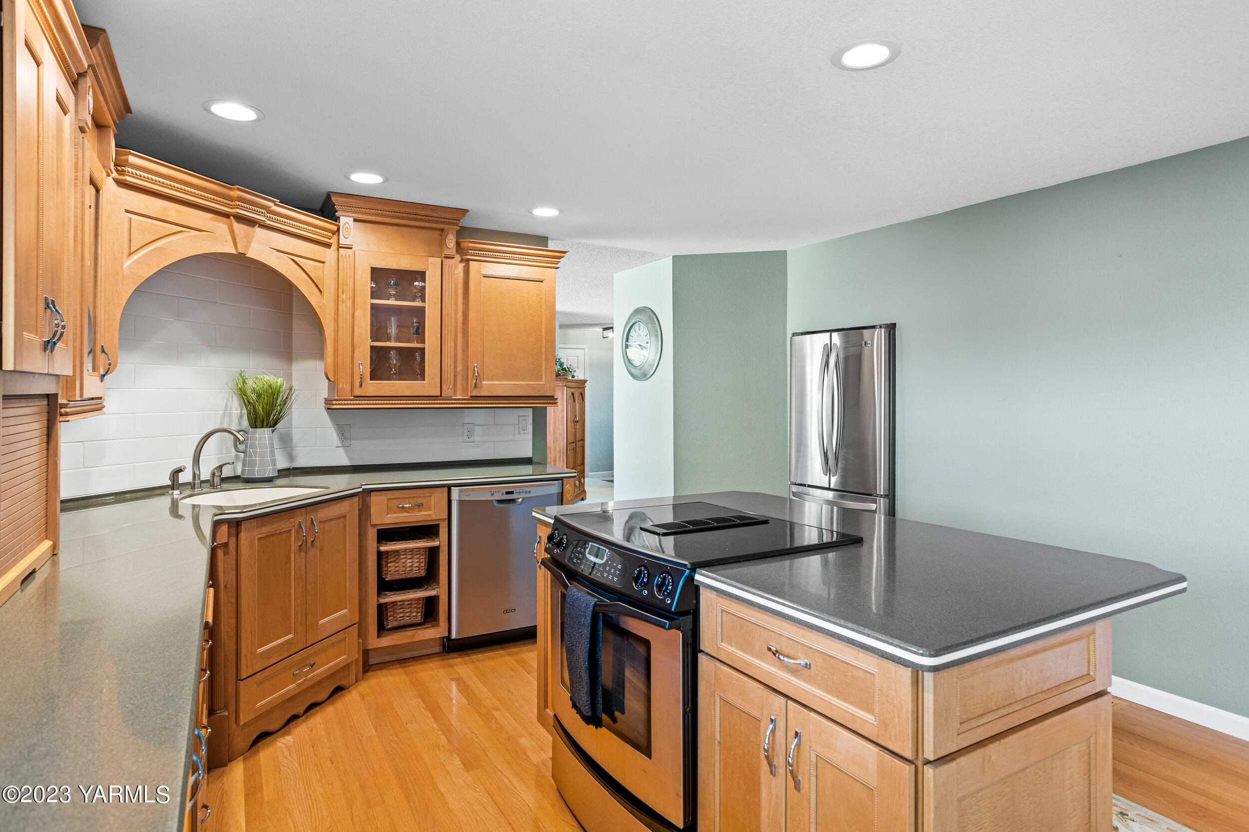 13518 Fisk Road Yakima, WA 98908 - Photo 19 of 58 a kitchen with stainless steel appliances granite countertop a stove a refrigerator and a sink
