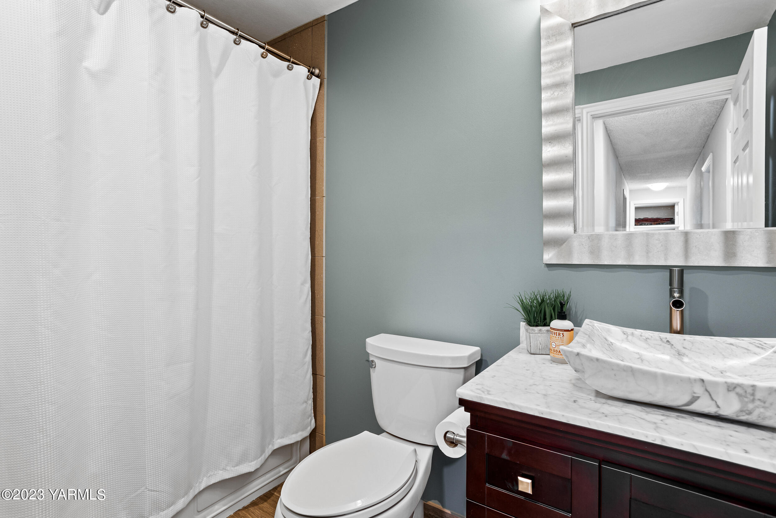 13518 Fisk Road Yakima, WA 98908 - Photo 31 of 58 a bathroom with a granite countertop sink and a mirror