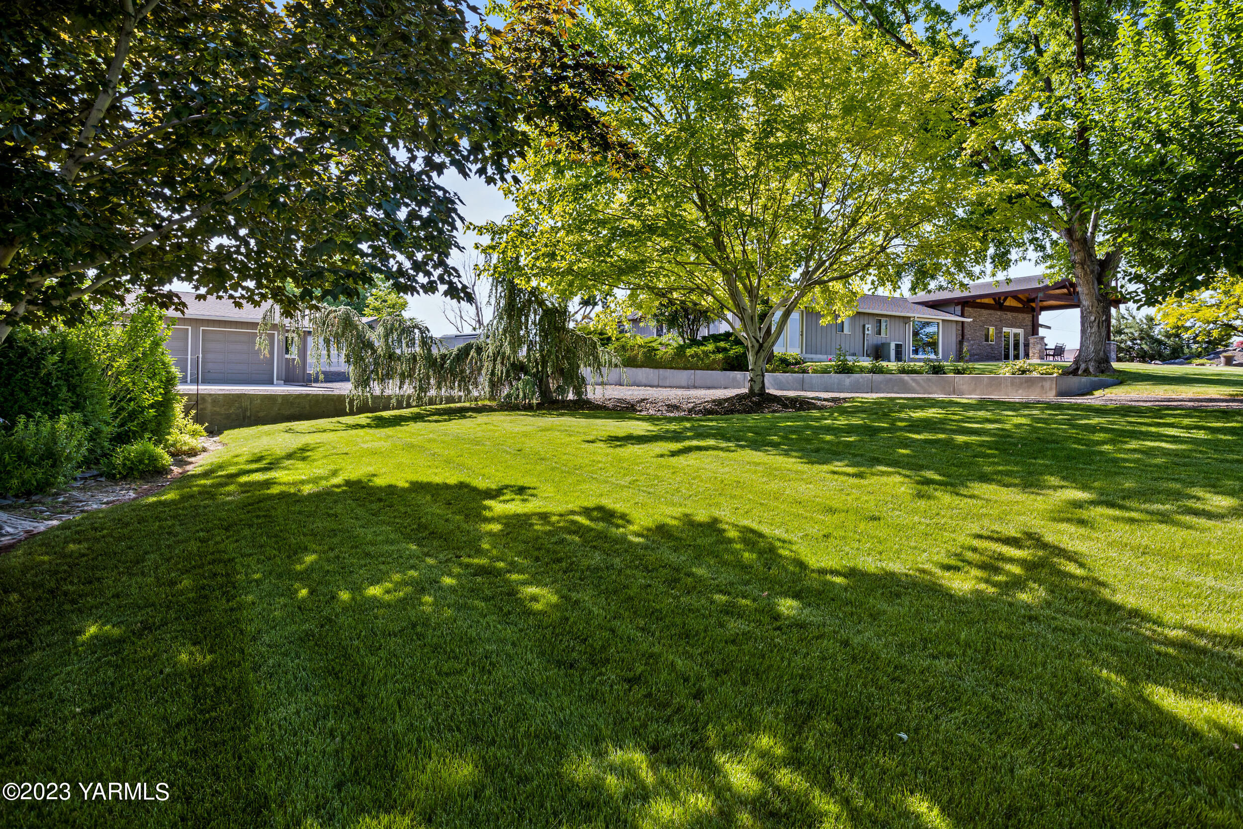 13518 Fisk Road Yakima, WA 98908 - Photo 51 of 58 a view of a house with a big yard and large trees