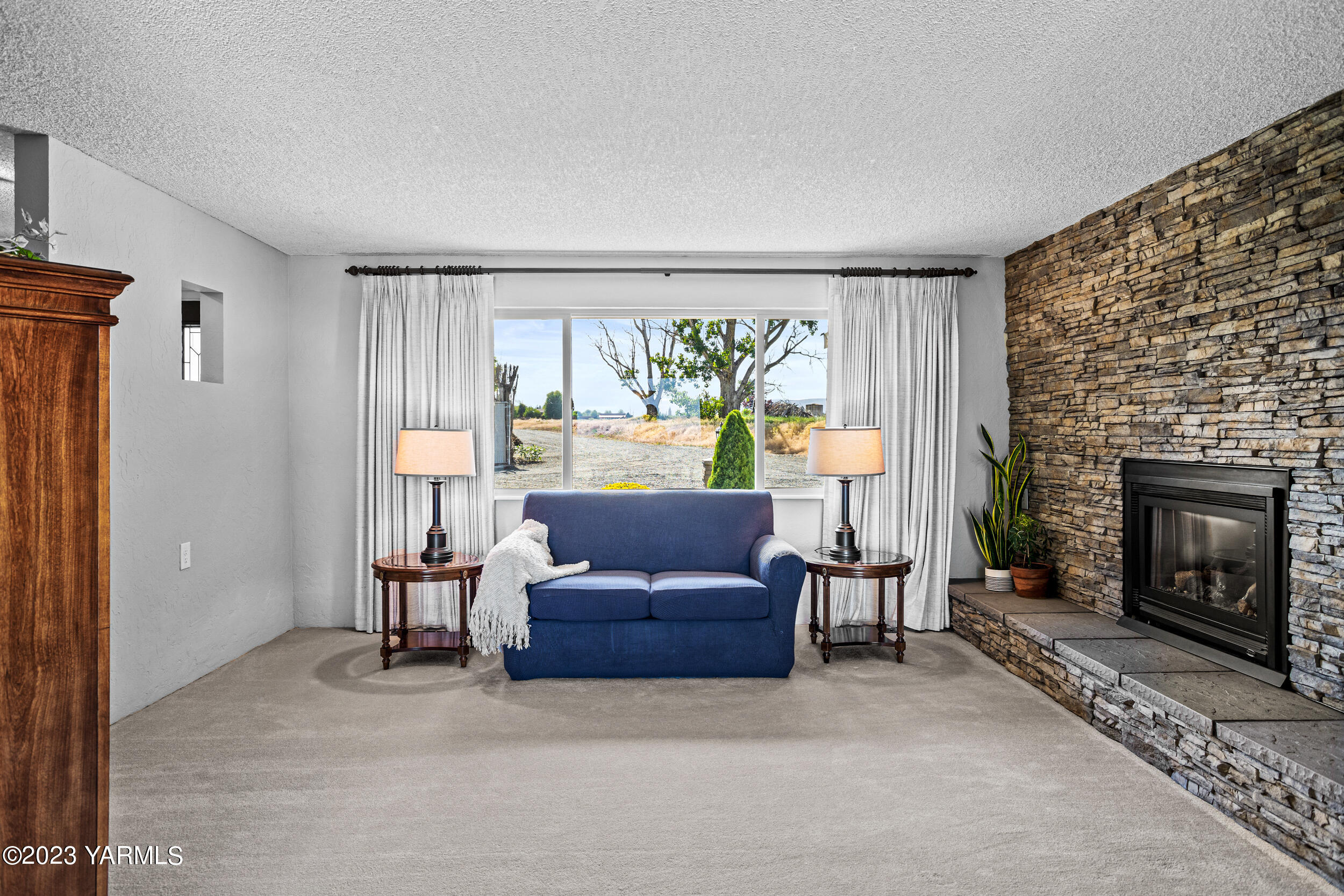 13518 Fisk Road Yakima, WA 98908 - Photo 8 of 58 a living room with furniture and a fireplace