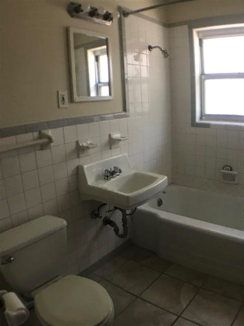 917 Keith Lane, Unit B Austin, TX 78705 - Photo 11 of 11 a bathroom with a sink a toilet and shower