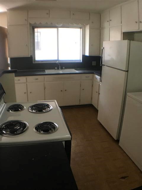 917 Keith Lane, Unit B Austin, TX 78705 - Photo 3 of 11 a kitchen with a stove a refrigerator and a sink