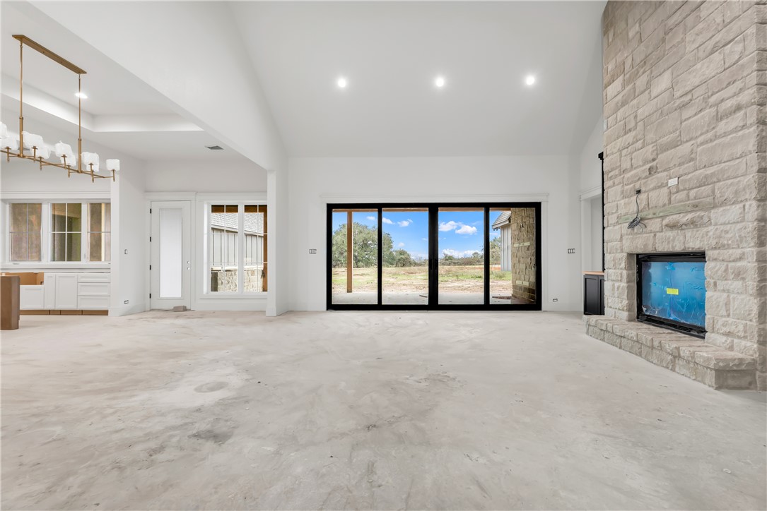 1141 Bluebonnet Ridge Drive Chappell Hill, TX 77426 - Photo 11 of 32 a view of an empty room with a fireplace and a window