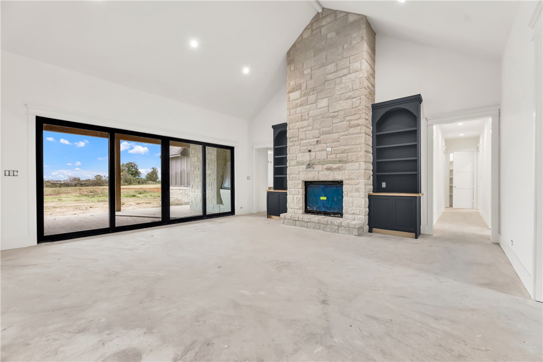 1141 Bluebonnet Ridge Drive Chappell Hill, TX 77426 - Photo 12 of 32 a view of an empty room with a fireplace and a large window