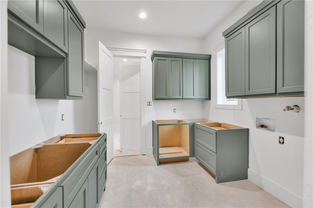 1141 Bluebonnet Ridge Drive Chappell Hill, TX 77426 - Photo 23 of 32 a kitchen with a sink and cabinets