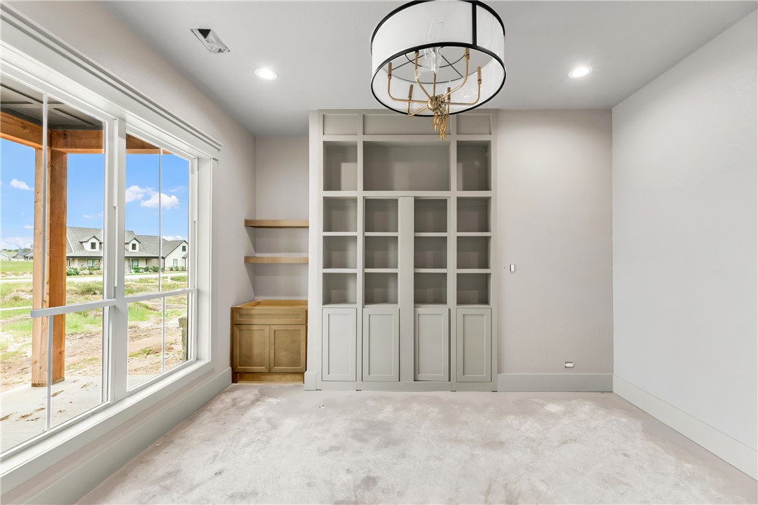 1141 Bluebonnet Ridge Drive Chappell Hill, TX 77426 - Photo 10 of 32 a view of an empty room with a window and kitchen