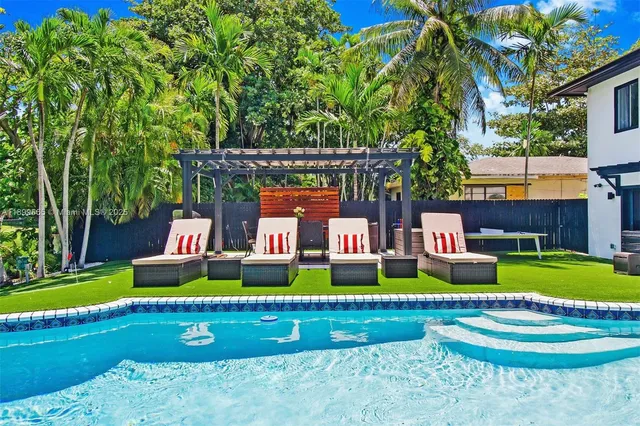 a view of swimming pool with lounge chair