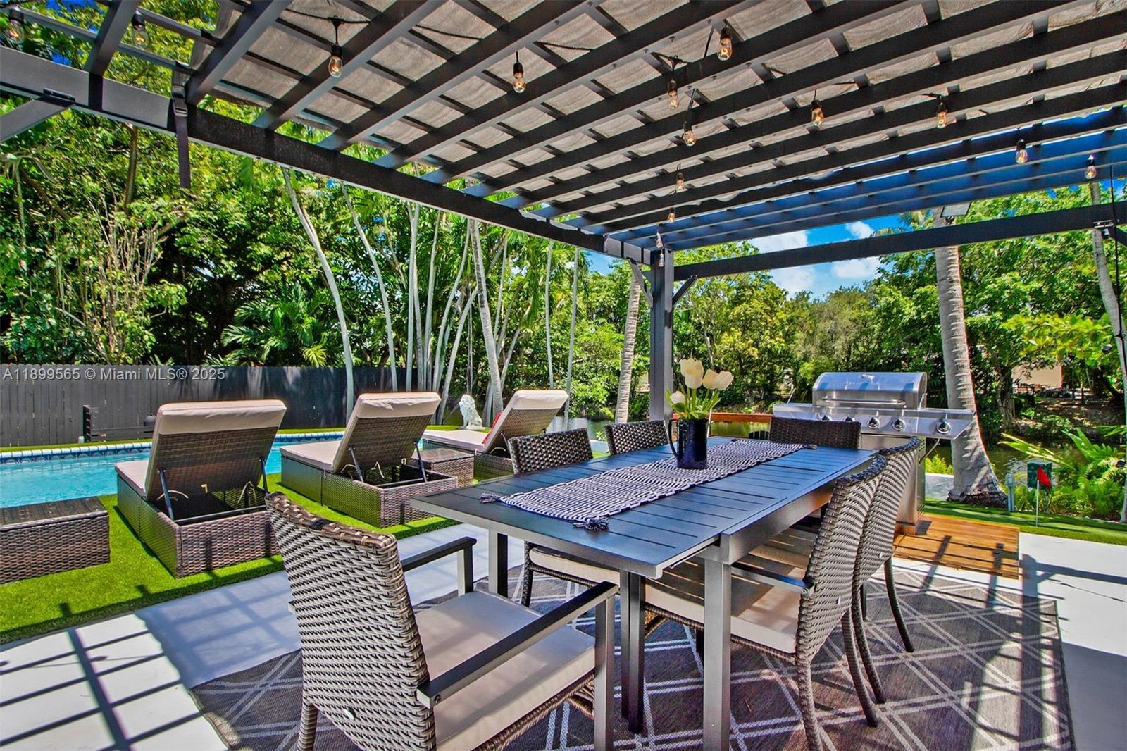 11975 West Biscayne Canal Road Miami, FL 33161 - Photo 17 of 58 a patio with glass top table and chairs