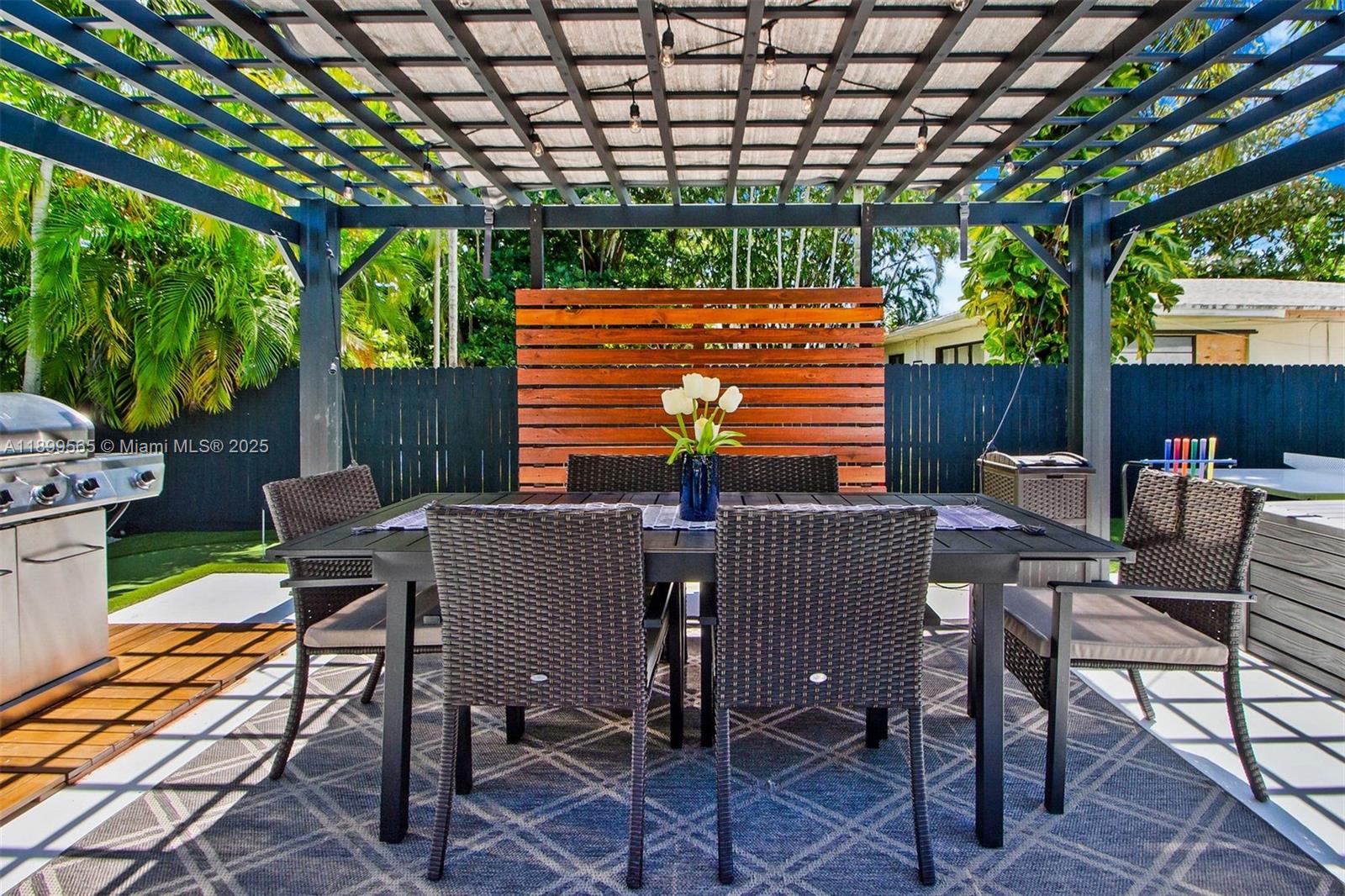 11975 West Biscayne Canal Road Miami, FL 33161 - Photo 18 of 58 a view of a patio with a table and chairs in the patio