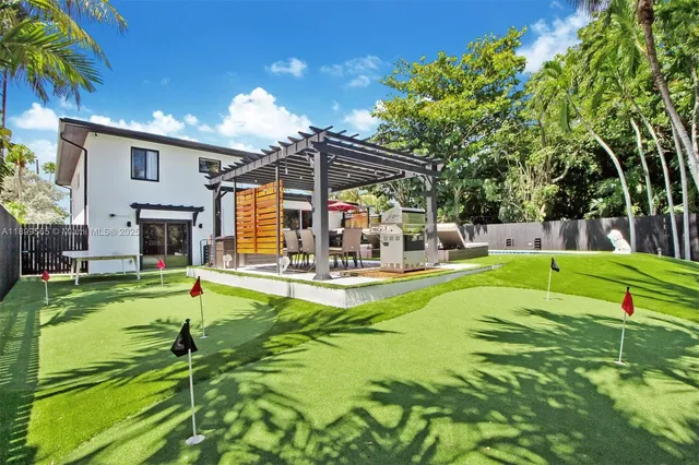 a view of a patio with table and chairs under an umbrella