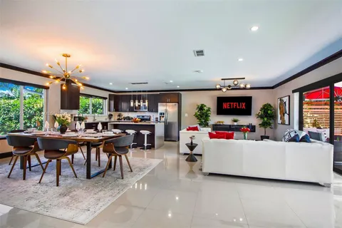 a living room with furniture chess board and a large window