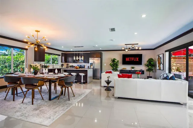 a living room with furniture chess board and a large window