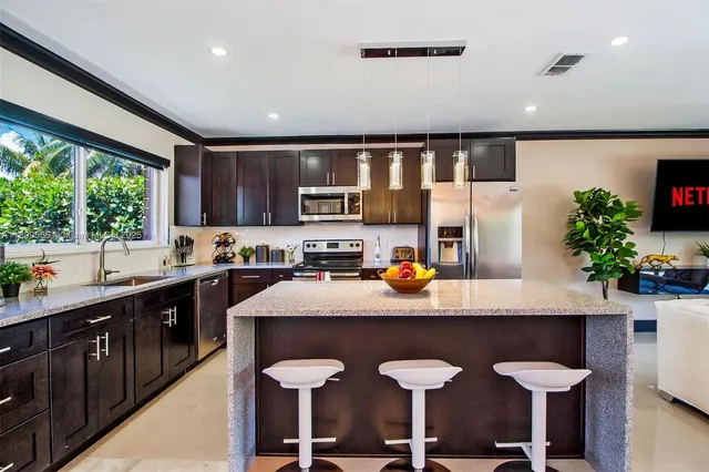 a living room with patio furniture and a large window