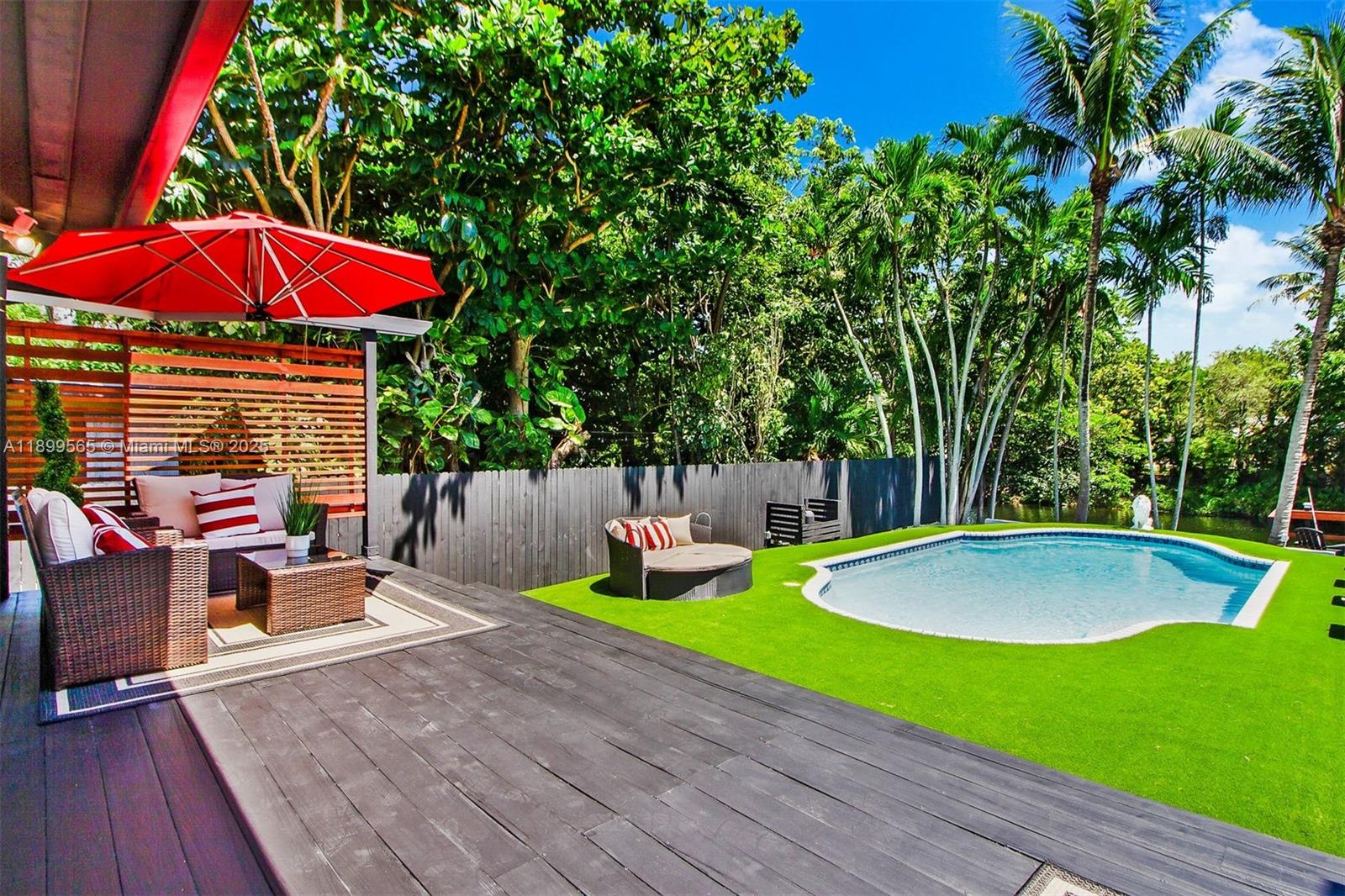 11975 West Biscayne Canal Road Miami, FL 33161 - Photo 3 of 58 a view of backyard with swimming pool and furniture