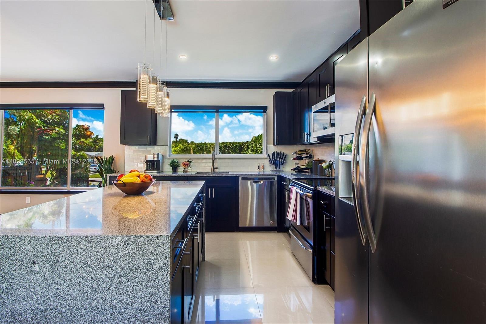 11975 West Biscayne Canal Road Miami, FL 33161 - Photo 38 of 58 a kitchen with stainless steel appliances granite countertop a sink stove and refrigerator