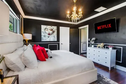 a bedroom with a bed a couch and a ceiling fan