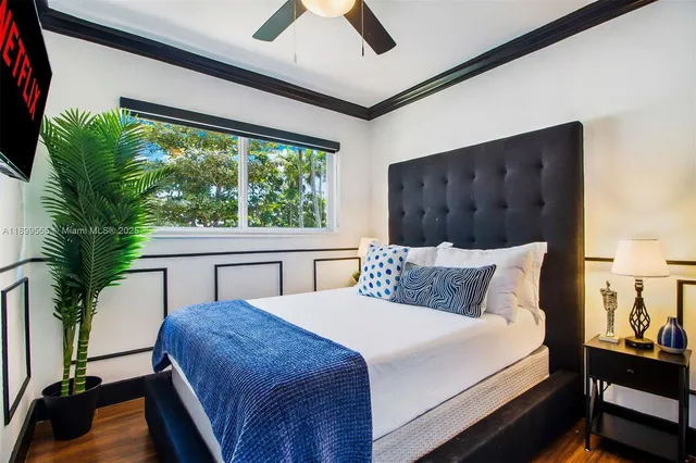 a bedroom with a bed and a floor to ceiling window