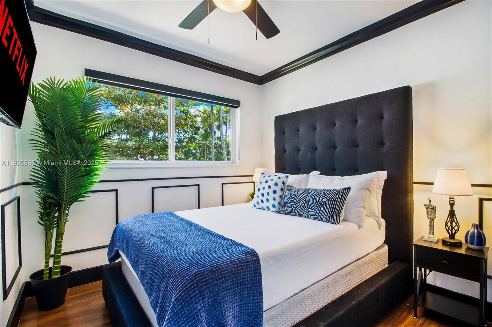 11975 West Biscayne Canal Road Miami, FL 33161 - Photo 42 of 58 a bedroom with a large bed and a large window