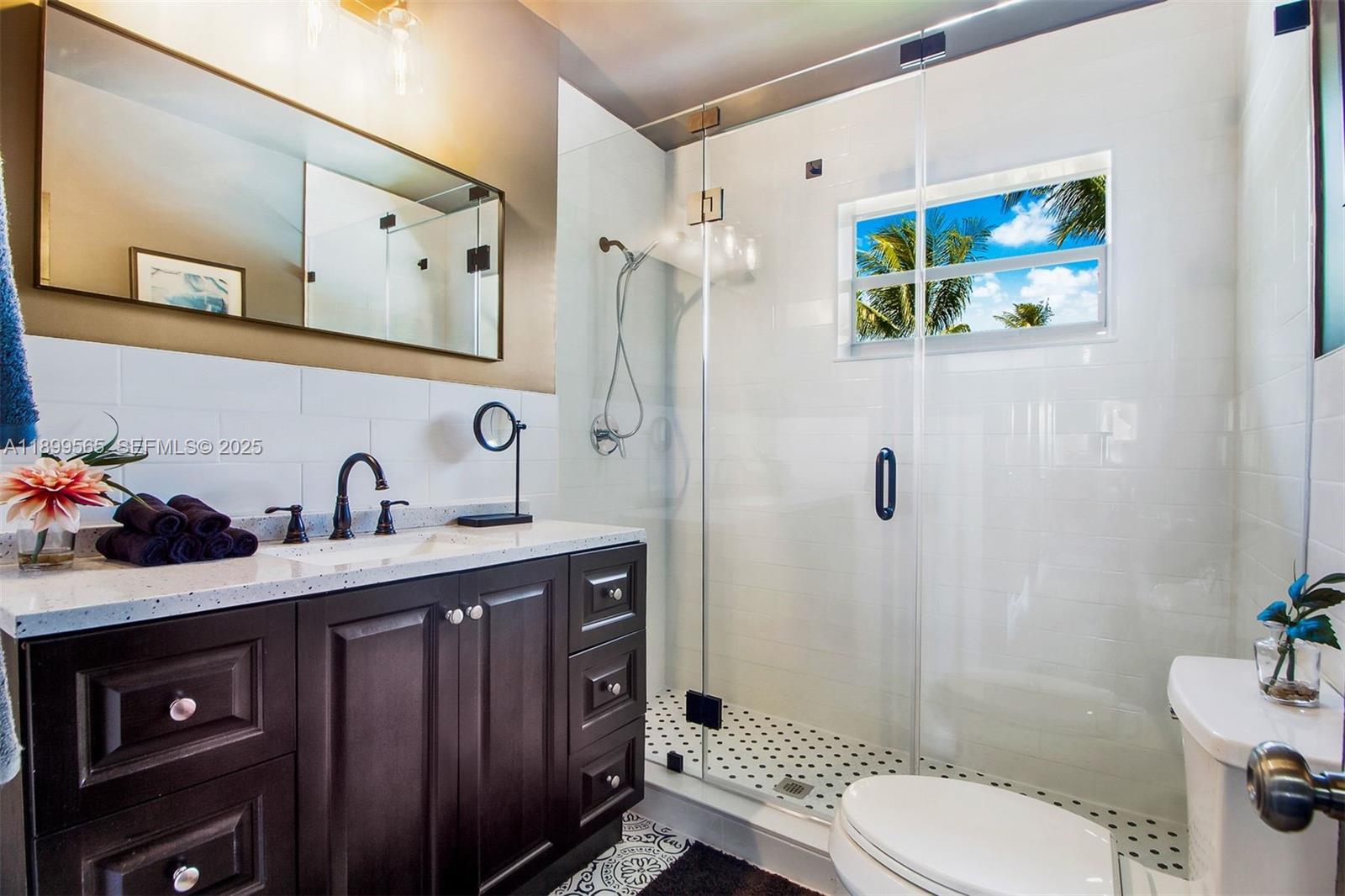 11975 West Biscayne Canal Road Miami, FL 33161 - Photo 43 of 58 a bathroom with a granite countertop sink toilet and shower