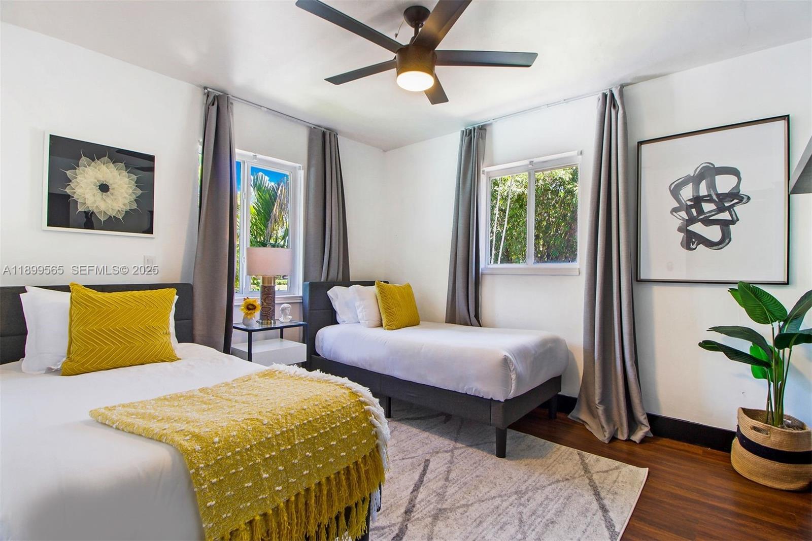 11975 West Biscayne Canal Road Miami, FL 33161 - Photo 44 of 58 a bedroom with a bed and a potted plant