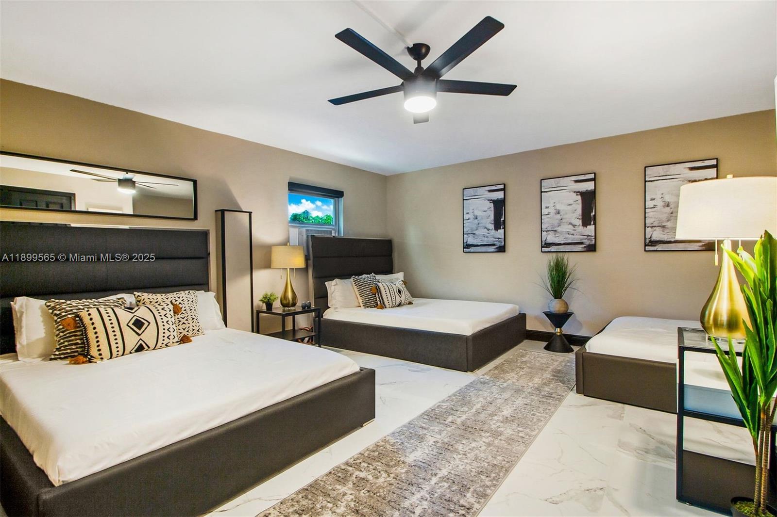 11975 West Biscayne Canal Road Miami, FL 33161 - Photo 47 of 58 a bedroom with a bed a couch and a ceiling fan