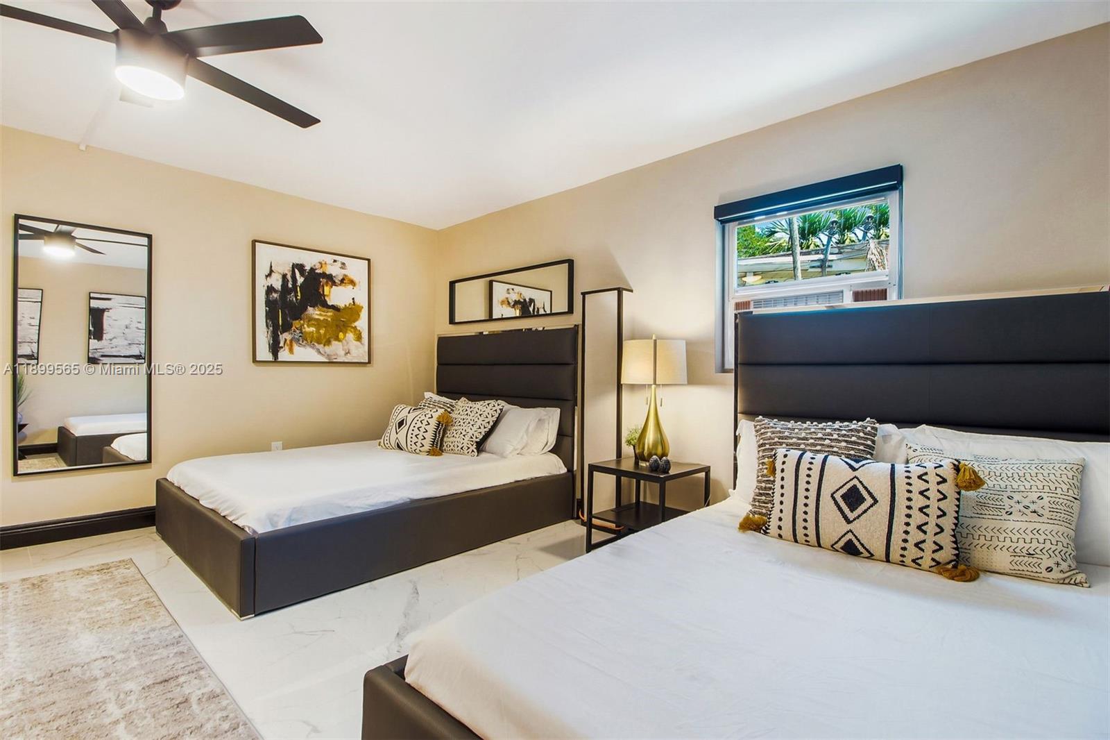 11975 West Biscayne Canal Road Miami, FL 33161 - Photo 48 of 58 a bedroom with a large bed and a chandelier