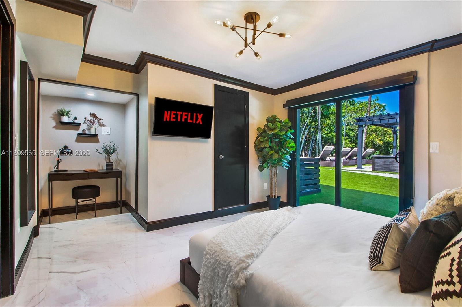 11975 West Biscayne Canal Road Miami, FL 33161 - Photo 50 of 58 a bedroom with a bed and a television