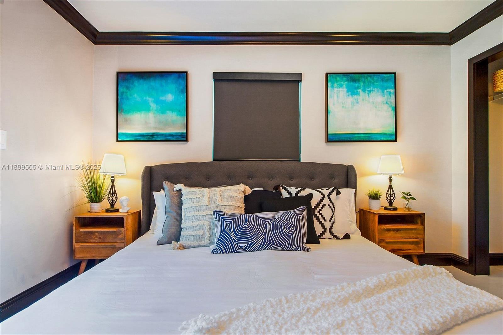 11975 West Biscayne Canal Road Miami, FL 33161 - Photo 51 of 58 a bedroom with a bed and a painting on the wall