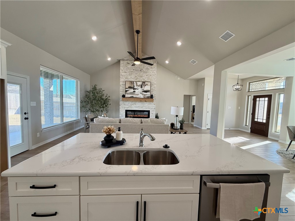 203 Lasso Loop Lorena, TX 76655 - Photo 11 of 36 a kitchen with a sink a stove and cabinets