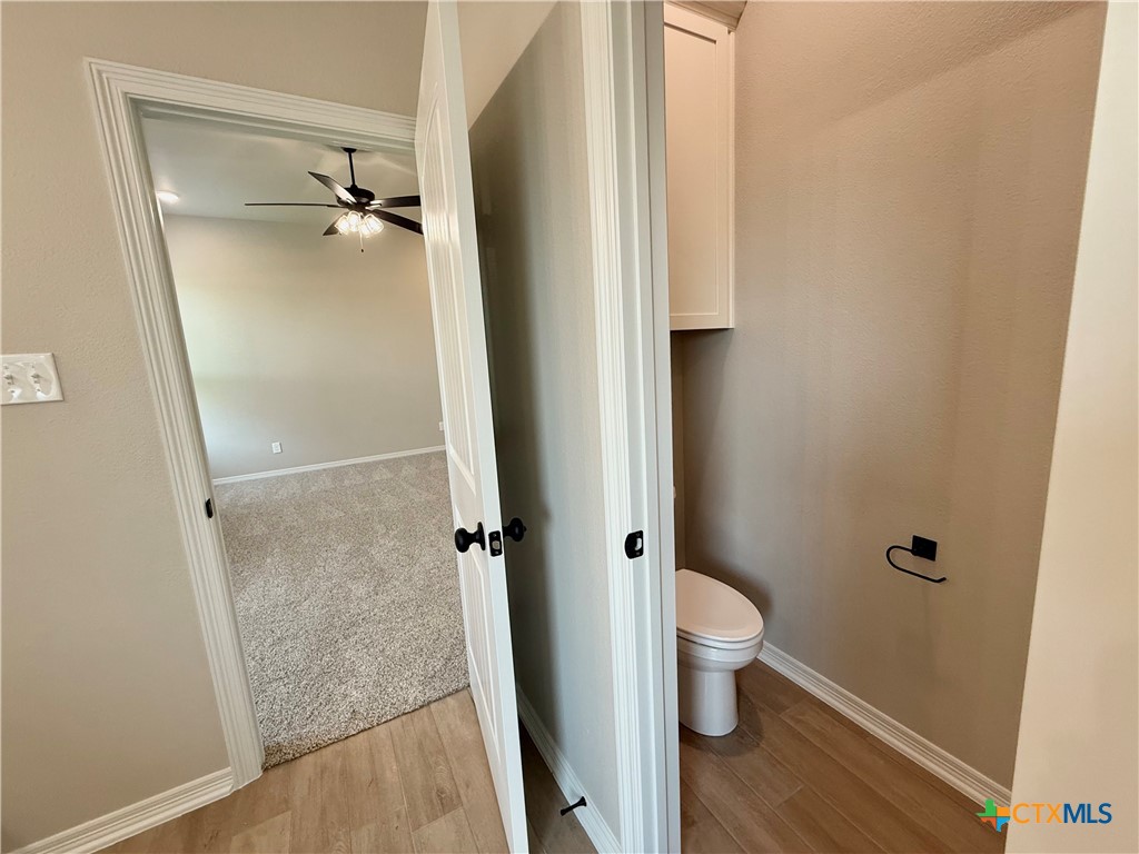 203 Lasso Loop Lorena, TX 76655 - Photo 15 of 24 a bathroom with a granite countertop toilet